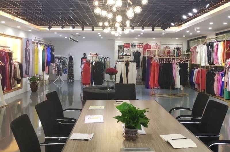 Professional bandage dress showroom featuring a wide selection of fashionable dresses and a dedicated client meeting area.