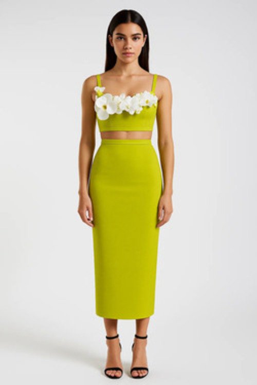 A model in a bright green bandage dress with floral embellishments