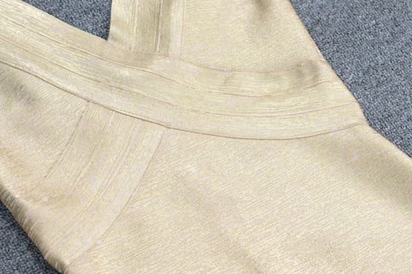 Close-up of metallic gold bandage dress fabric
